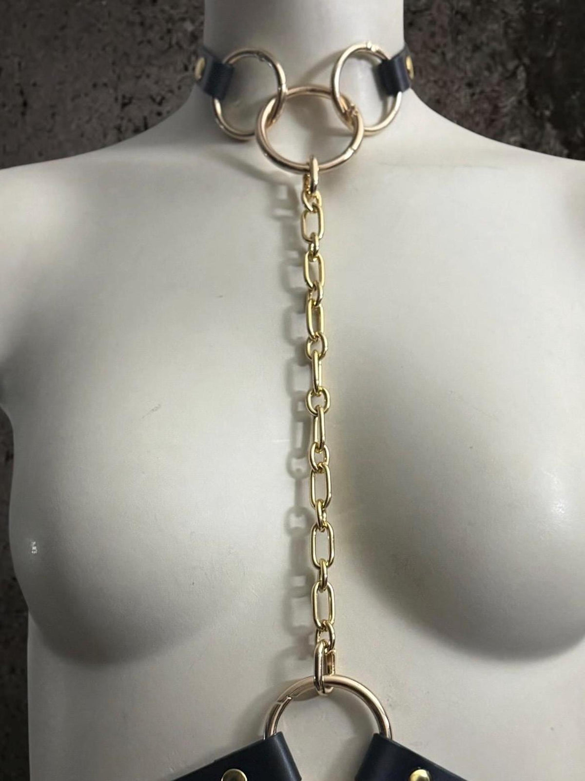 Collar with long gold chain drop to chest ring, convertible leather body harness component, bold statement
