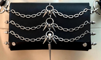 Flat lay front view of spiked leather crossbody bag, three rows of chains, stainless steel spike hardware