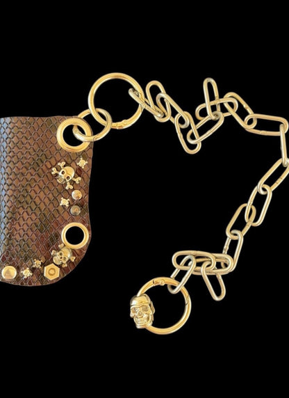 Gold detachable chain and assorted linking rings on black background, chain style option for leather lighter case with chain