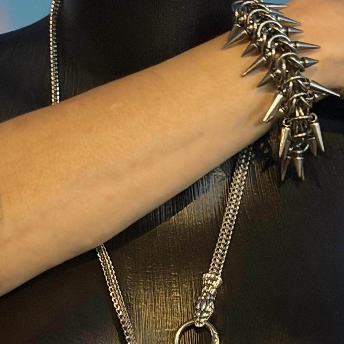 Spiked bracelet close-up, sharp chain spikes from harness repurposed as punk festival jewelry on wrist.