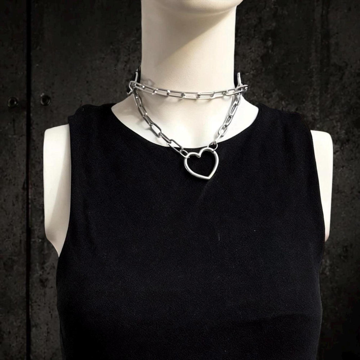 Close front view shows heart choker necklace on mannequin, chunky stainless steel layered chain choker