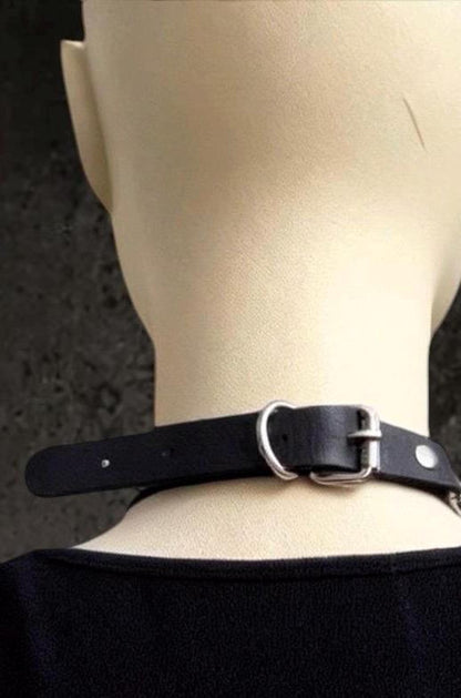 Back neck view shows adjustable black leather choker strap, silver buckle closure, pairs with stainless chain layers