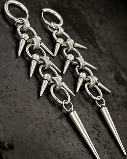 Macro detail of linked chainmail sections and clustered small spike charms on gothic spike dangle earrings