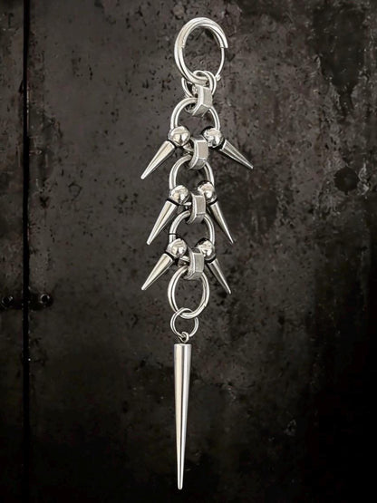 Centered single dangling straight on dark field, long gothic earrings with linked rings and sharpened spike drop