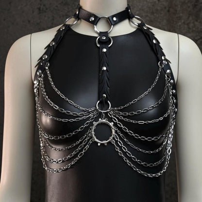Black mannequin with gothic chain body harness over black top, faux leather straps, reclaimed rubber and silver layered chains.