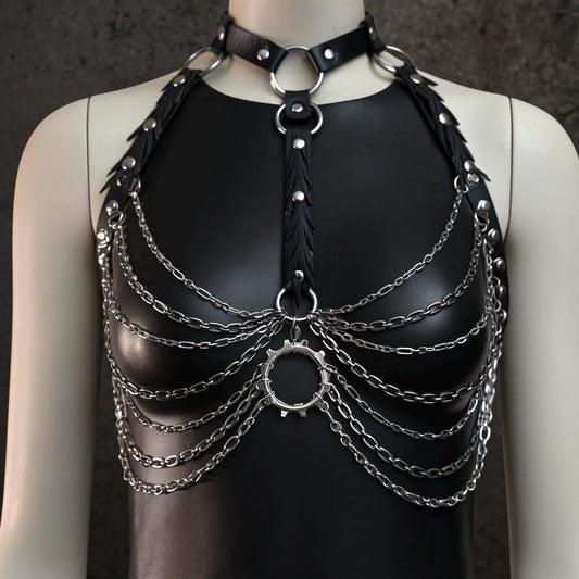 Black mannequin with gothic chain body harness over black top, faux leather straps, reclaimed rubber and silver layered chains.