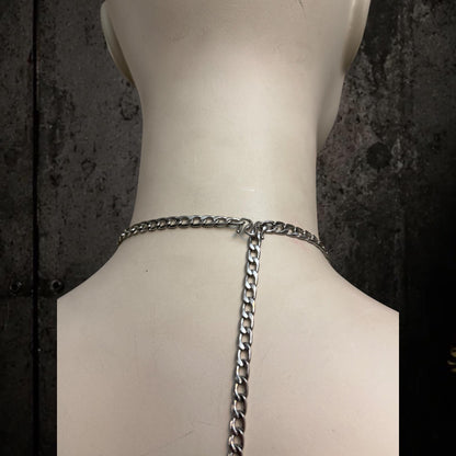 Back neck close-up on white mannequin, adjustable body harness tail chain and clasp, silver links show customization and fit.