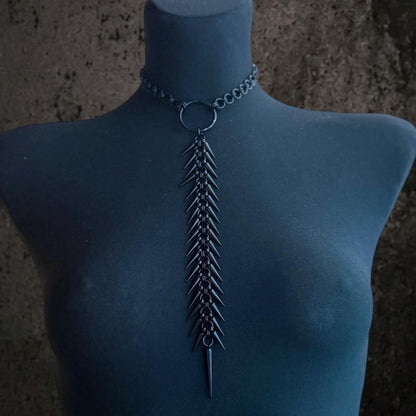 Black finish spine necklace on dark mannequin, choker chain with long articulated spine pendant