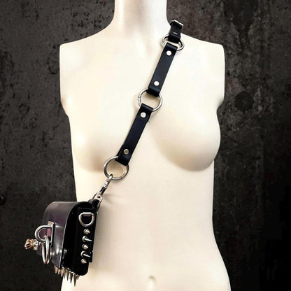 Single-shoulder bag strap variant, convertible leather harness clipped to a small leather pouch at hip