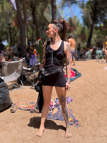Festival model wearing spine body chain, silver stainless steel torso chain jewelry, rave ready edgy styling
