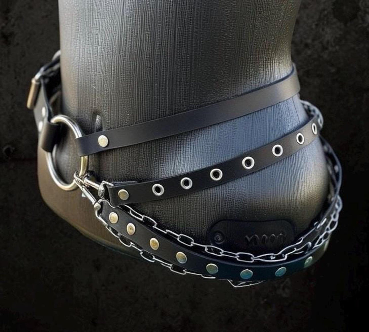 Angled three-quarter shot, detachable chain sections hooked to grommet strap, convertible chain belt styling