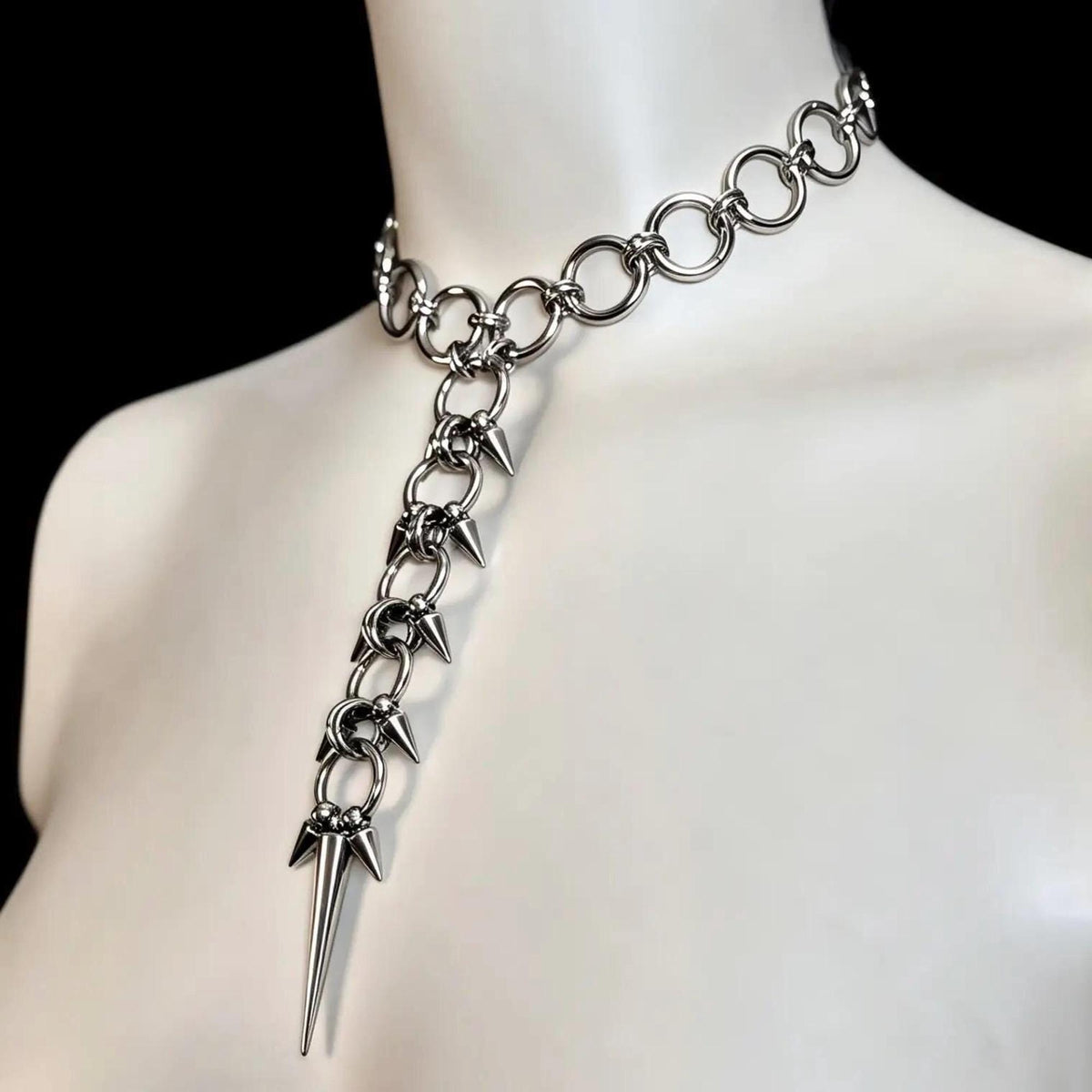 Side neck angle on mannequin, dramatic long lariat pendant and layered spikes, gothic choker necklace, spiked spine necklace.